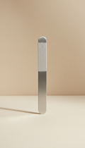 Minimalist stainless steel nail file, Default is a clean 3/4 angle for each tool, presented on a neutral matte surface...